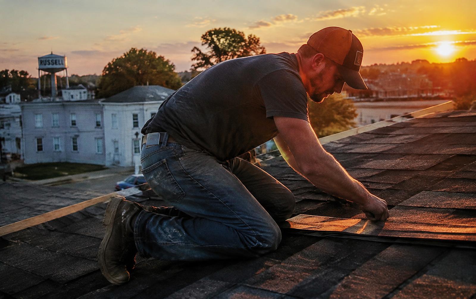 Roofer on a roof at golden hour